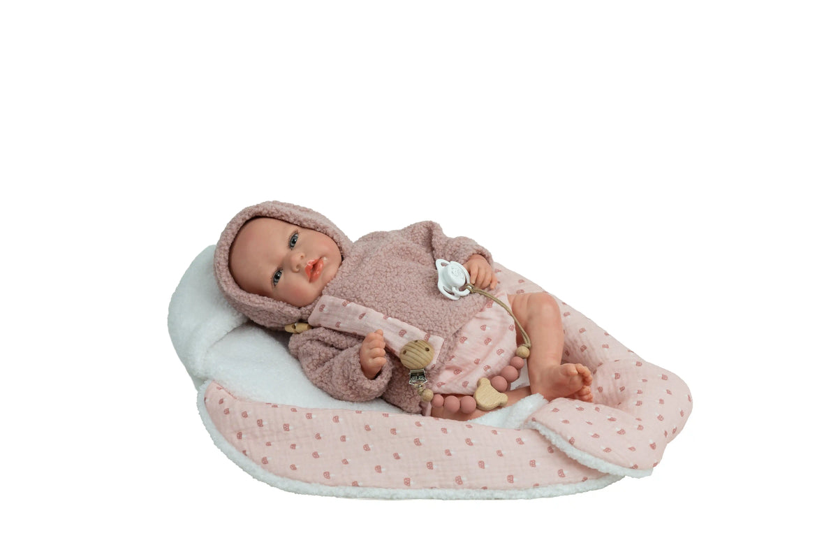 Muñeca Reborn Luna Rosa de Muñecas Arias tumbada sobre su manta nido rosa y blanca