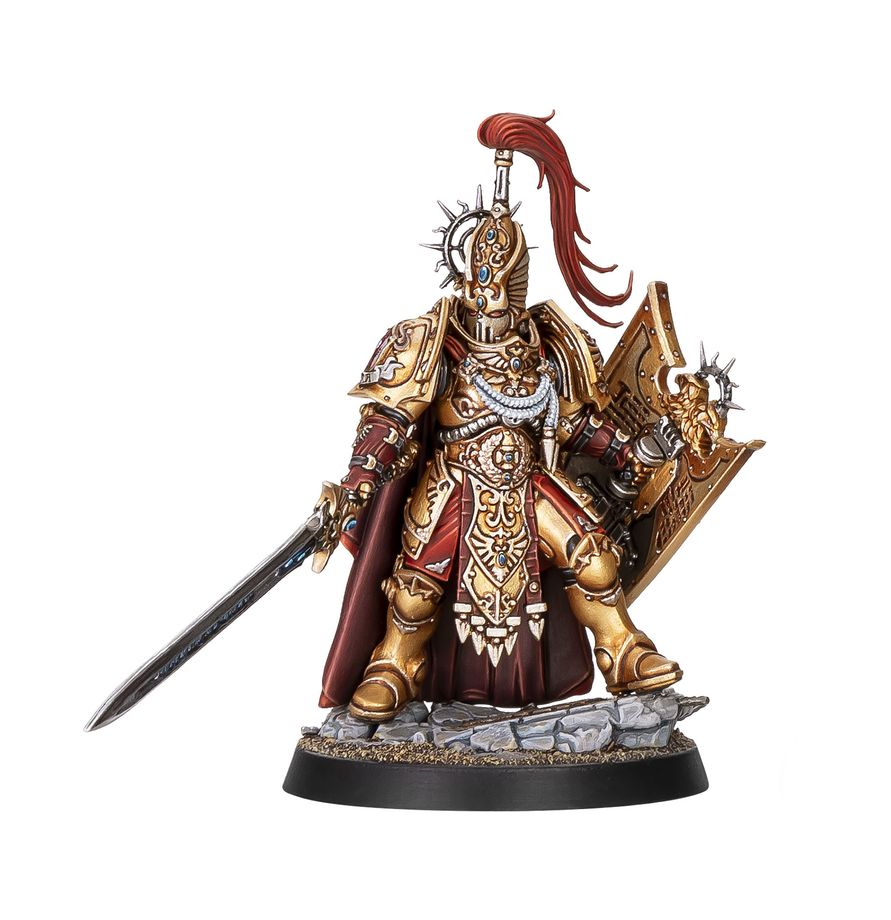 Capitán Escudo Custodes de Warhammer con armadura dorada, casco con penacho rojo, espada eternidad y escudo praesidium.