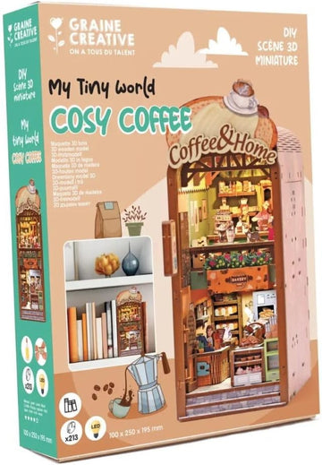 Caja de la maqueta Cosy Coffee con luz LED de Graine Créative, con cafetería en miniatura y ejemplo entre libros.