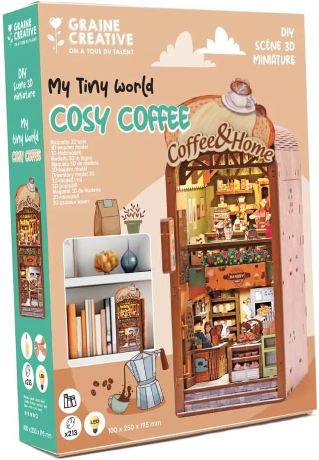 Caja de la maqueta Cosy Coffee con luz LED de Graine Créative, con cafetería en miniatura y ejemplo entre libros.
