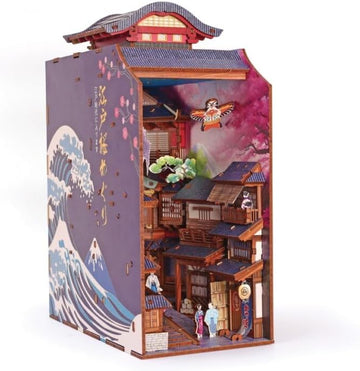 Maqueta soporte de libros Sakura con luz de Graine Créative, vista lateral con ola japonesa y calle en miniatura.