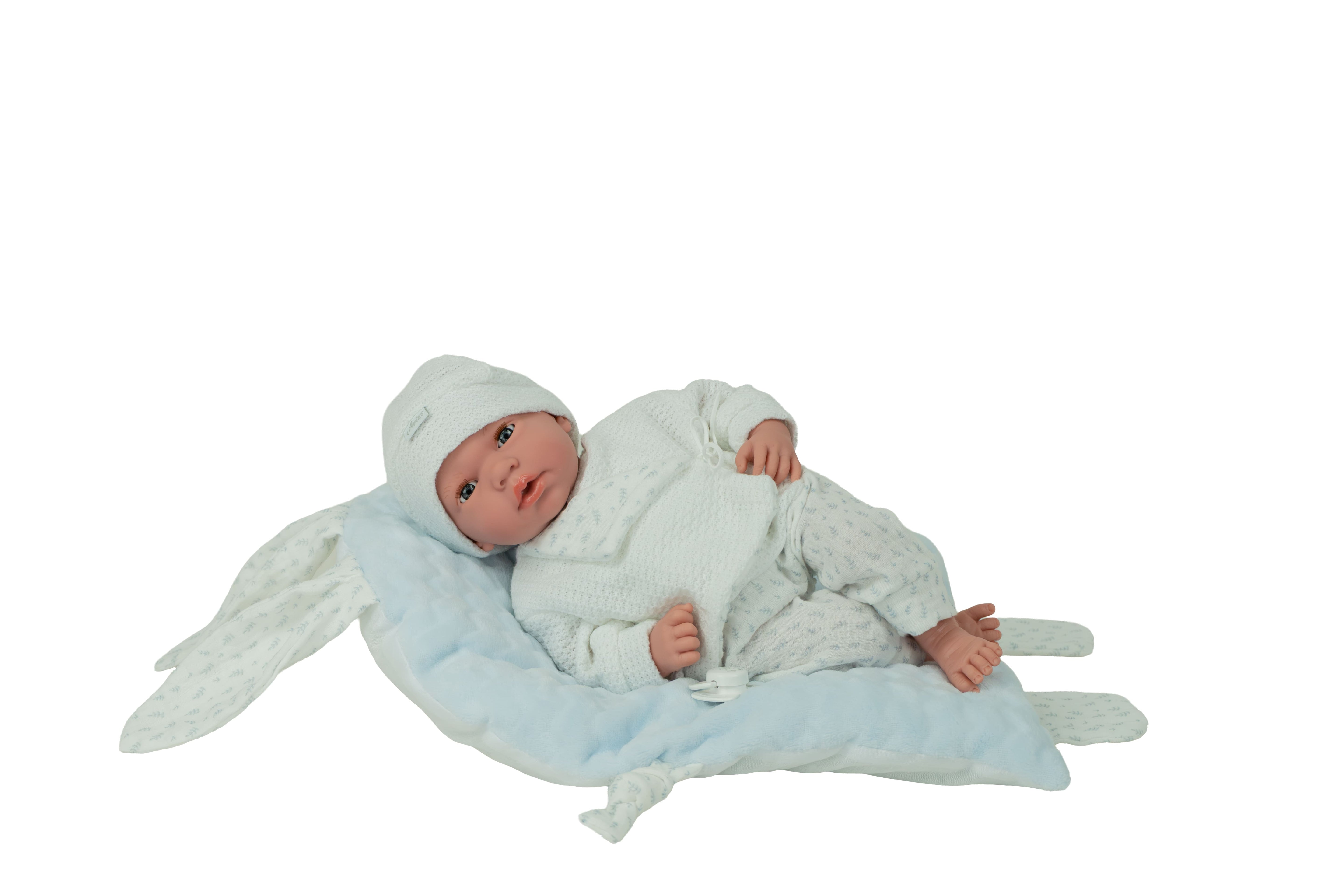 Muñeca bebé Andie Arias 40 cm tumbada sobre cojín azul de orejitas, ropita blanca y azul, cuerpo blando con extremidades de vinilo